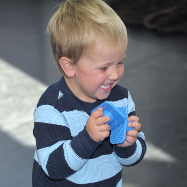 Early preschooler uses zig zag blocks during music classes for kids.